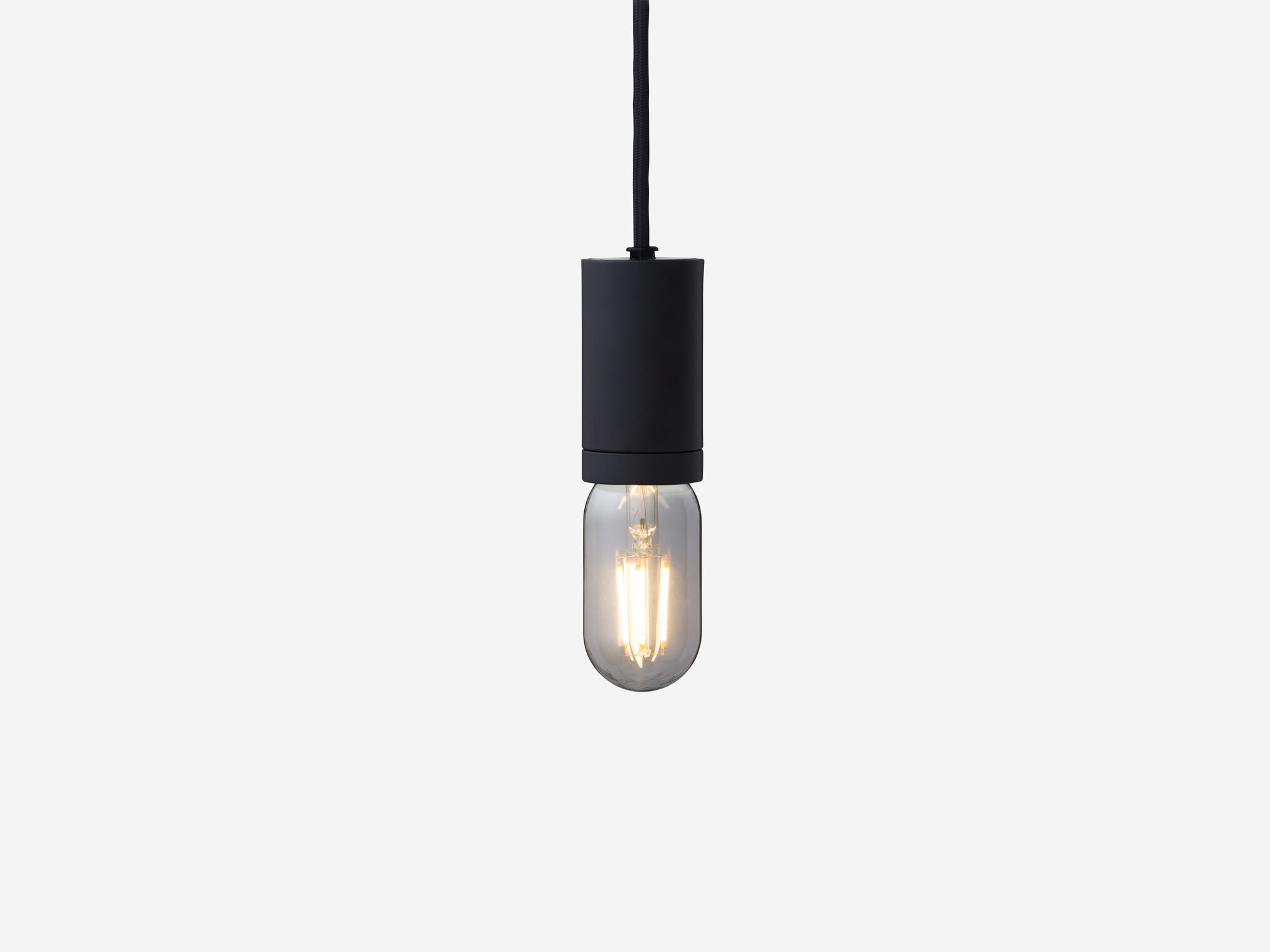 Front view of extra small smoked grey lightbulb hanging from black hardware